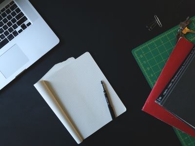 Picture of desk with Macbook and Notebooks